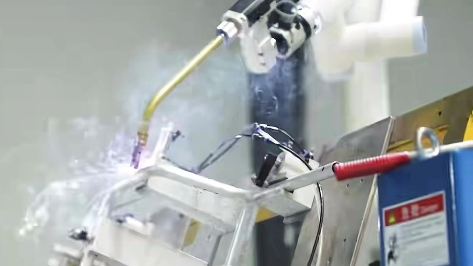 Smart manufacturing application: collaborative robotic arm welding assist in an industrial workcell.